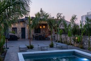 a villa with a swimming pool and a house at Maria - Christina House in Soroni