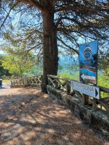 a sign next to a tree next to a fence at Casa Vacanze Nicola e Lina in Tortorella