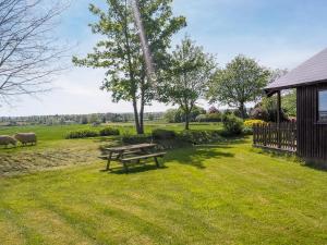 a picnic table in a field with sheep in the background at Robin Lodge - E4478 in Nawton