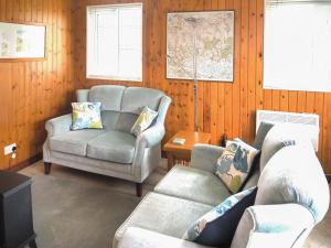a living room with two chairs and a couch at Robin Lodge - E4478 in Nawton +5 photos
