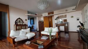 a living room with two couches and a coffee table at B&B La Dimora di Charme in Basiglio