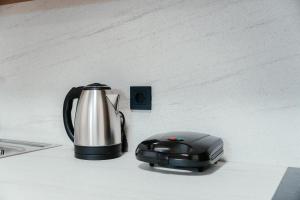 a tea pot and a kettle on a counter at Aida's Apartment Nafplio in Nafplio