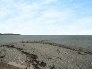 a beach with a large body of water at Jura in Drummore