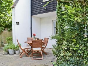 a table and chairs sitting on a patio at Crown Cottage in Hartest