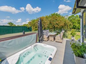 a jacuzzi tub on the back of a patio at Sunnyfields in Cambridge