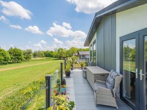 a porch with chairs and a view of a field at Sunnyfields in Cambridge