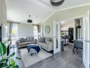 a living room with two couches and a kitchen at Sunnyfields in Cambridge