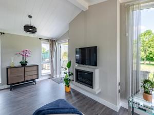 a living room with a fireplace and a flat screen tv at Sunnyfields in Cambridge +12 photos