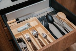 a drawer with silver utensils in a cabinet at Aida's Apartment Nafplio in Nafplio