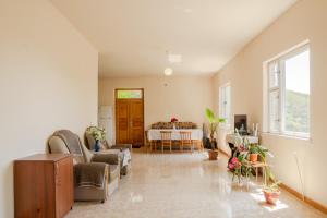 a living room with a table and chairs at NNN Guest House in Goris