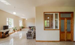 a living room with a couch and a tv at NNN Guest House in Goris
