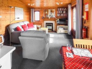 a living room with a couch and a chair at Wren Lodge - E5023 in Nawton +6 photos