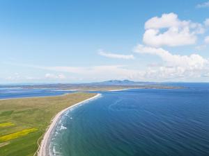 an aerial view of an island in the ocean at Husabost House in Carinish