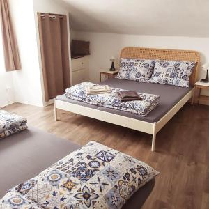 a bedroom with two beds with pillows at Domeček in Třeboň