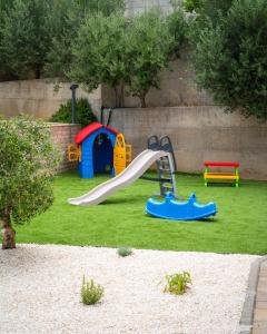 a playground with a slide and a play house at Villa Malo More in Trogir