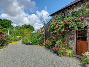 a garden with flowers on the side of a building at Little Forda in Chillaton