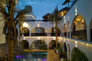 a courtyard with a swimming pool in a building at Nyota Boutique Hotel Zanzibar in Nungwi