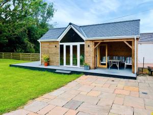 a house with a deck and a patio at Stronvaar in Stranraer