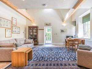 a living room with a couch and a table at The Old Stable in Dursley