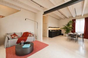 a living room with a couch and a table at Resort Casa del Monte 1553 in Albenga