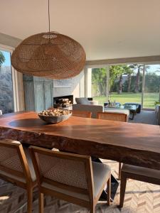 a dining room with a large wooden table and chairs at Casa Catalina - Oceanfront house Lima in Lima