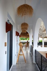 a hallway with a dining room with a table at Nyota Boutique Hotel Zanzibar in Nungwi