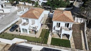 an aerial view of a large white house with a car at Mgd House in Santa Domenica