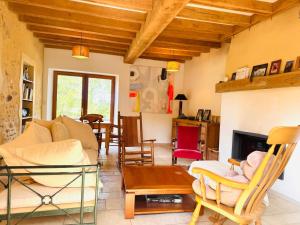 a living room with a couch and a fireplace at La Masure in Les Rameaux