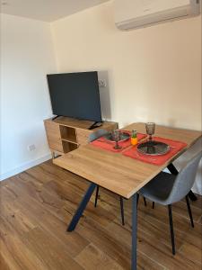 a wooden table with two glasses on top of it at chez ophélia in Sainte-Tulle