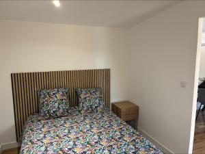 a bedroom with a bed with two pillows at chez ophélia in Sainte-Tulle