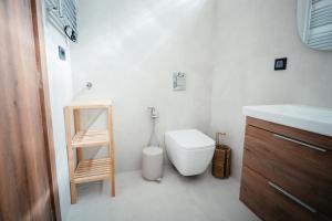 a white bathroom with a toilet and a sink at Aida's Apartment Nafplio in Nafplio +16 photos