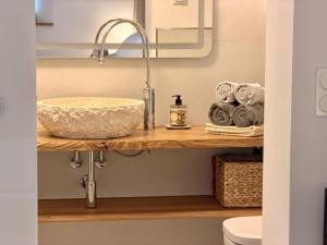 a bathroom with a sink and towels on a shelf at Gimmeldinger Haus in Neustadt an der Weinstraße +37 photos