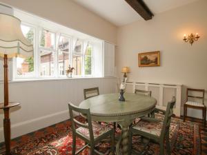 a dining room with a table and chairs at The Butlers Quarters in Much Wenlock