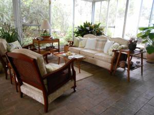 a living room with a couch and chairs at Whispering Pines Bed and Breakfast in Collie