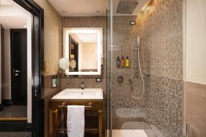 a bathroom with a sink and a shower at The Venice Times Hotel, Vignette Collection by IHG in Venice +99 photos