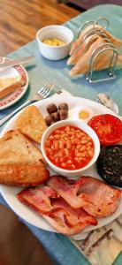 a plate of food with beans and bread on a table at Globe Guesthouse in Burry Port