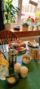 a table topped with plates of food on a table at Globe Guesthouse in Burry Port
