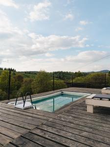 a swimming pool on the deck of a house at Horizon Славсько з чаном,басейном in Khashchovanoye