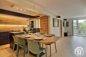 a kitchen with a large wooden table and chairs at Ker helios in Dinard