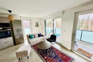 a living room with a couch and a chair at The Ill in Softness calm & elegant in Illkirch-Graffenstaden +22 photos