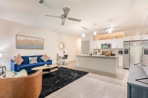 a living room with a blue couch and a kitchen at Riverwalk View Luxe Condo Views Pool Free Parking in San Antonio
