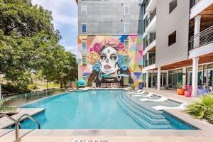 a mural on the side of a building with a pool at Riverwalk View Luxe Condo Views Pool Free Parking in San Antonio
