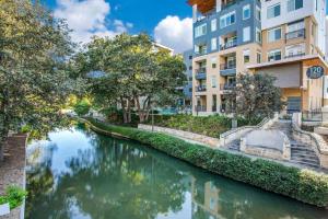 a river in a city with buildings at Riverwalk View Luxe Condo Views Pool Free Parking in San Antonio
