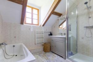 a bathroom with a shower and a tub and a sink at Gîte de la Savenée in Saint-André-en-Morvan +21 photos