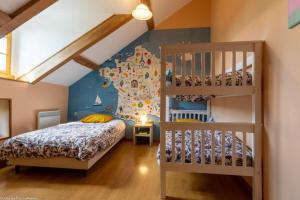 a bedroom with a bunk bed and a ladder at Gîte de la Savenée in Saint-André-en-Morvan