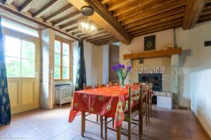 a dining room with a table and a fireplace at Gîte de la Savenée in Saint-André-en-Morvan