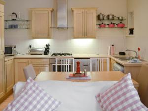 a kitchen with a table with two pillows on it at Percy's Place in Alnwick