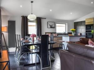 a kitchen and living room with a table and a couch at The Lune - Uk47035 in Kirkby Lonsdale