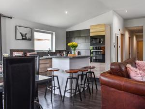 a kitchen and living room with a couch and a bar at The Lune - Uk47035 in Kirkby Lonsdale