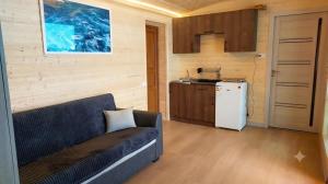 a living room with a couch and a kitchen at Tsovazard Holiday House in Tsovazard